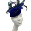 Royal blue velvet teardrop base with an array of peacock feathers and a green jewelled detail to the centre.
